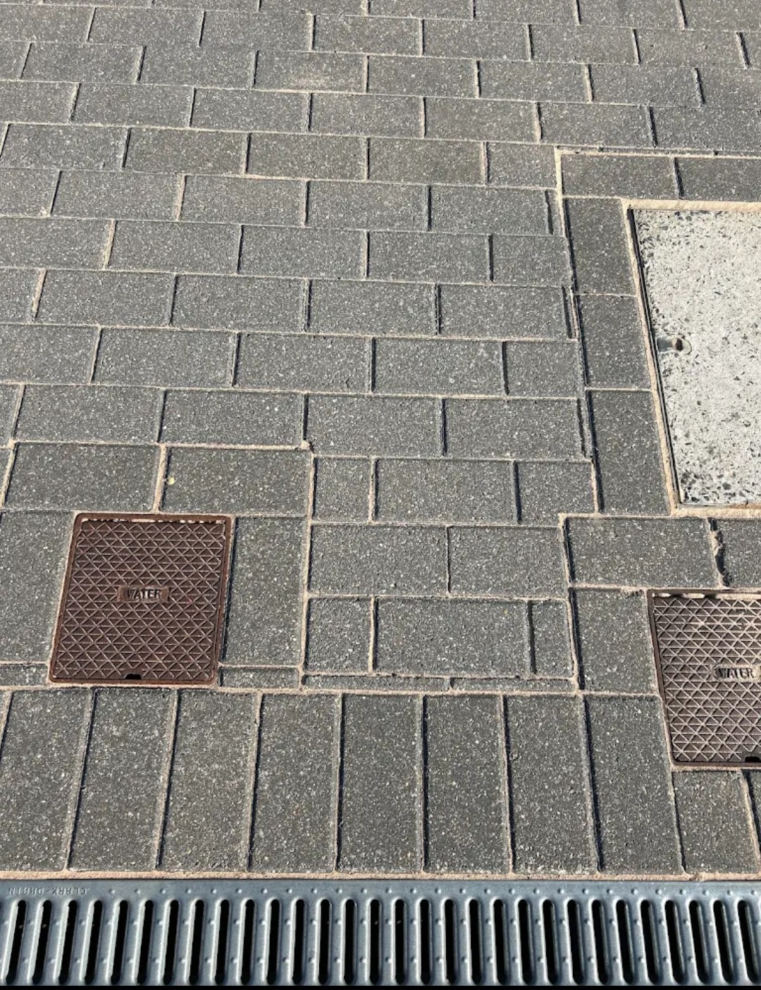 Close-up of grey block paving with clean joints and drainage