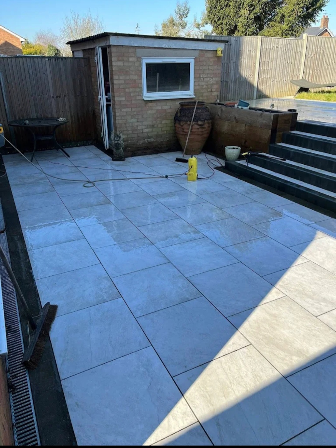 Large grey porcelain tiled patio after deep cleaning