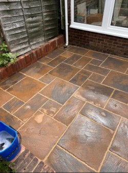 Restored natural stone patio after pressure washing