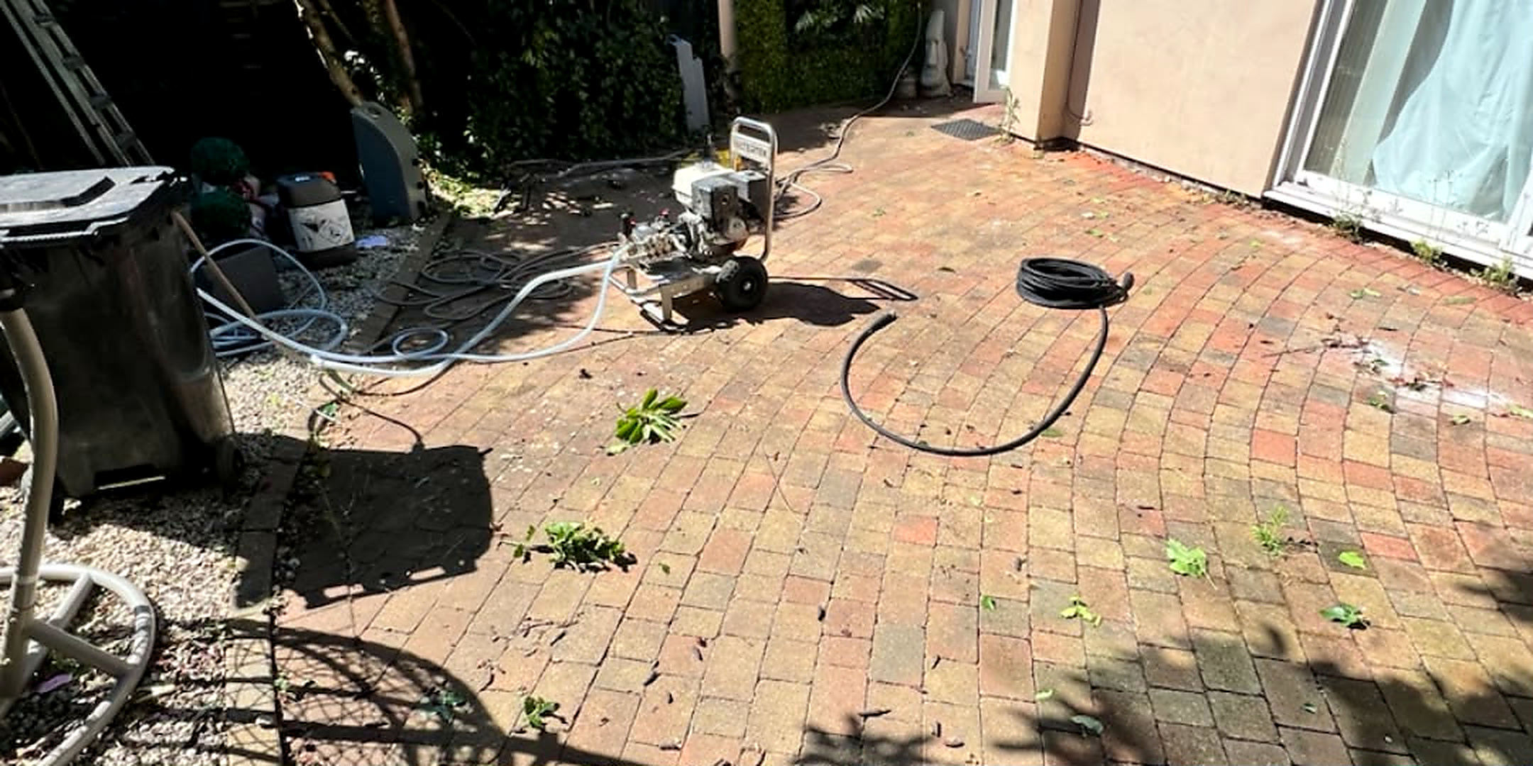 Circular brick paved patio cleaned — before