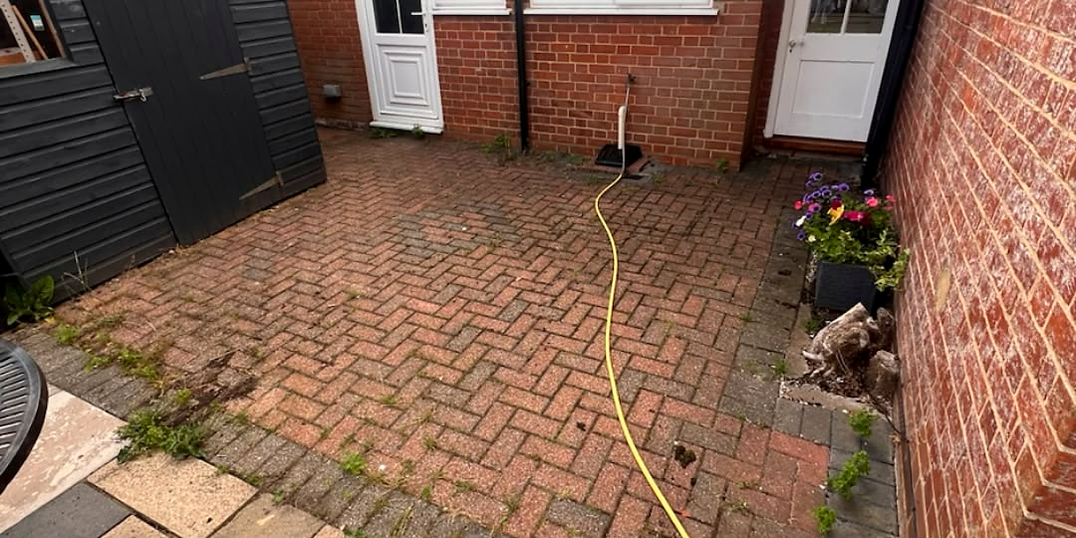 Rear brick courtyard cleaned — before