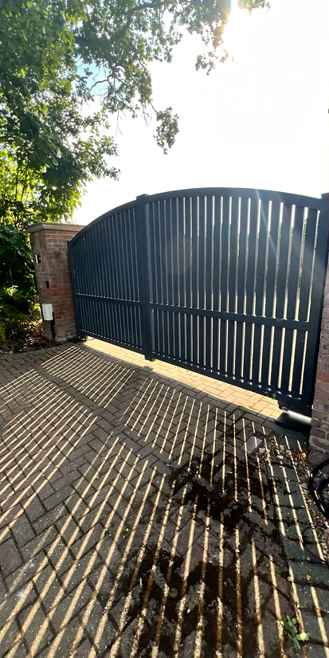 Block paved gated entrance deep cleaned — before