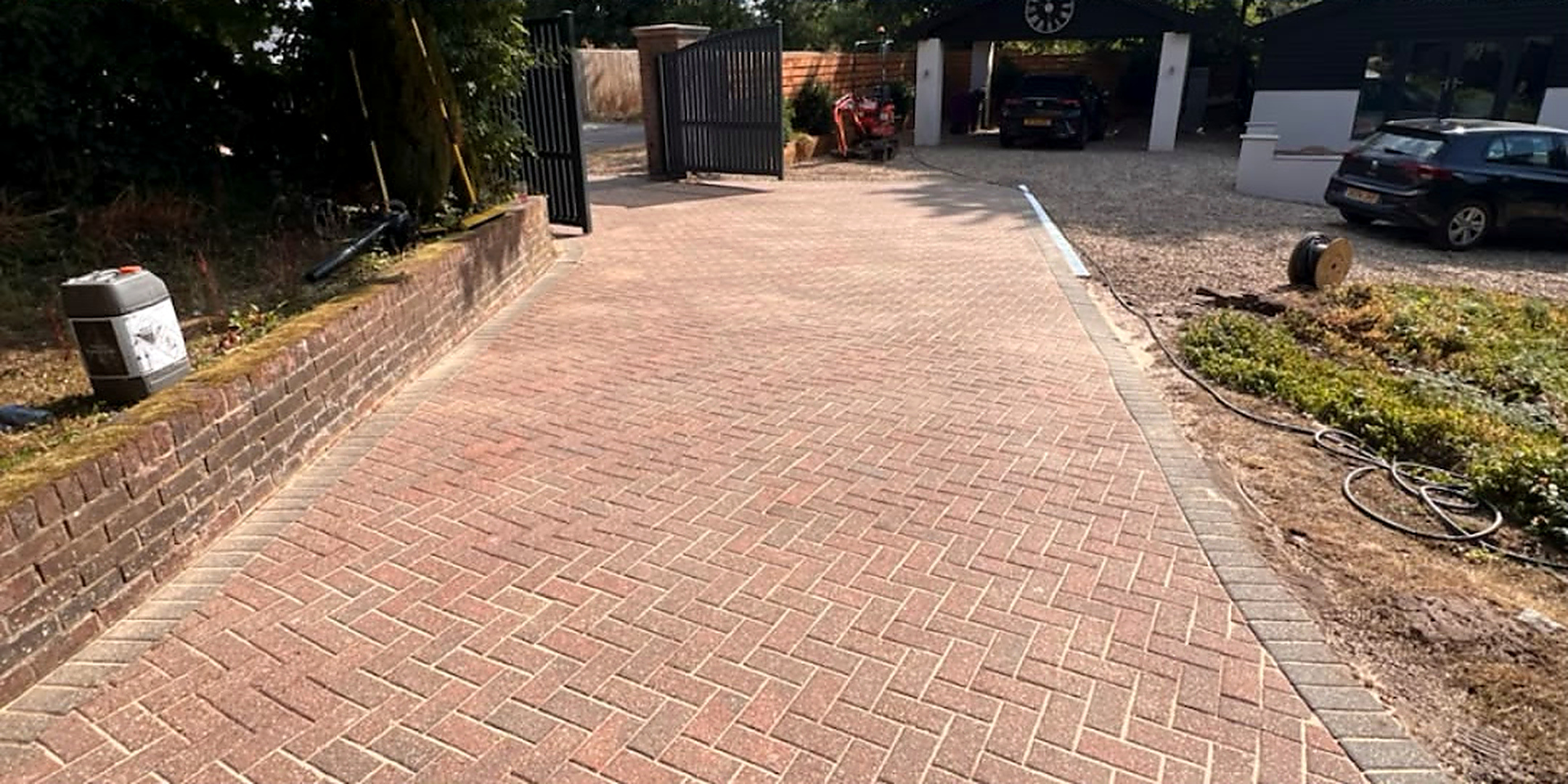 Block paved driveway before and after cleaning and re-sanding — after