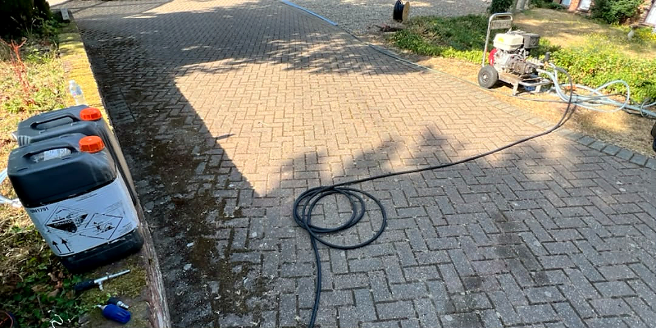 Block paved driveway before and after cleaning and re-sanding — before