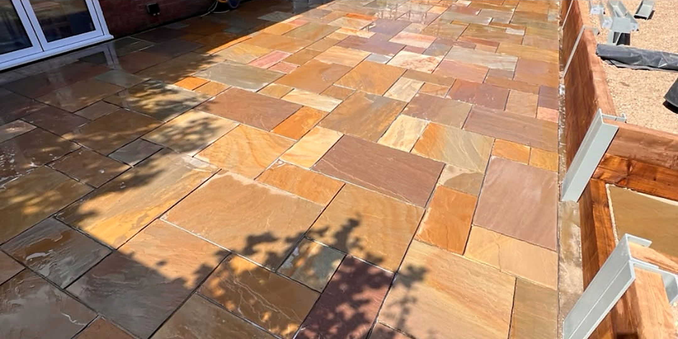 Indian sandstone patio restored to its natural colour — after